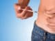 Man puncturing a dose of insulin on his belly