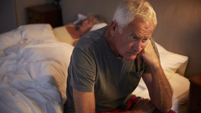 Worried Senior Man In Bed At Night Suffering With Insomnia