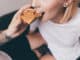 Cropped shot of men feeding girlfriend with toast with peanut butter for breakfast