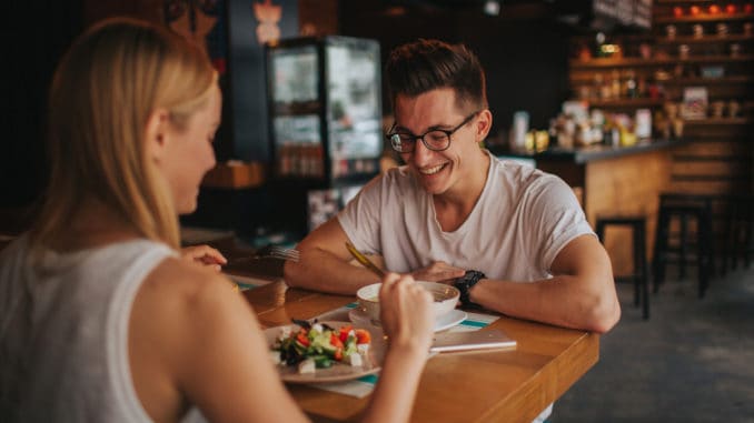 Happy young couple in love having a nice date in a bar or restaurant.