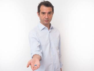 Man showing a bunch of medicine pills in his hand