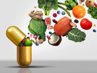 Vitamins supplements as a capsule with fruit vegetables nuts and beans inside a nutrient pill as a natural medicine health treatment