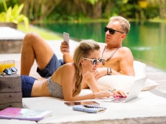 Stress free couple relaxing in hot summer day and using tech