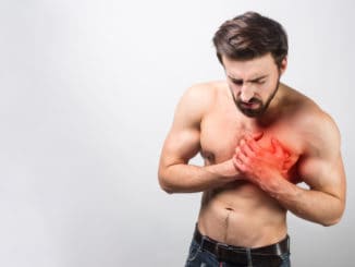 Picture of young and good-looking having a heart ache in his chest.