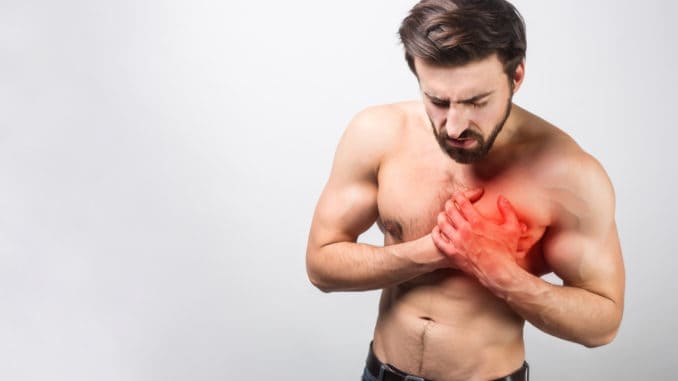 Picture of young and good-looking having a heart ache in his chest.