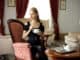 Attractive woman having tea time in a luxury hotel room