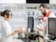 Man buying medication standing with pharmacist at the counter of the pharmacy store