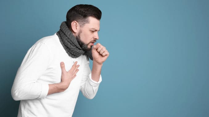 Mature man coughing on color background