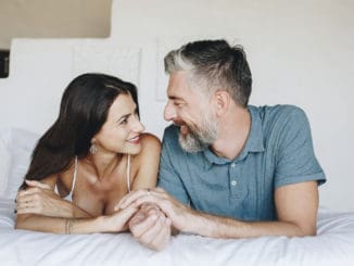 Couple spending their honeymoon in bed