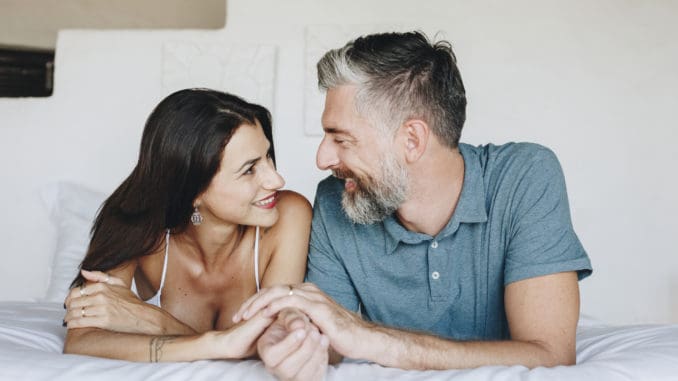 Couple spending their honeymoon in bed