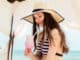 woman in beach vacation drinking a cocktail in pavilion