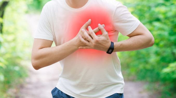 Man with heart attack, injury while running, trauma during workout Man with heart attack