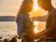 Silhouette of smiling couple in love embrace each other at the beach against sun. Summer flirt in shorts and bikini.