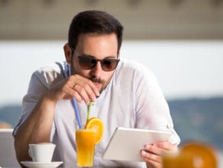 Handsome man with sunglasses drinking orange juice