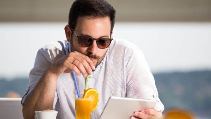 Handsome man with sunglasses drinking orange juice