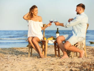 Young couple with glasses of wine