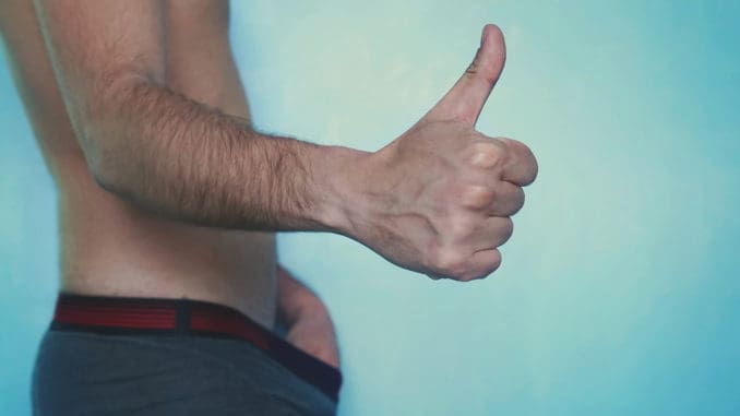 dreamstime_m_128321997 Impotence concept. Man is looking on his penis inside boxers and is showing thumb up