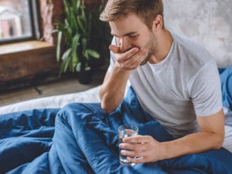 young man taking pill