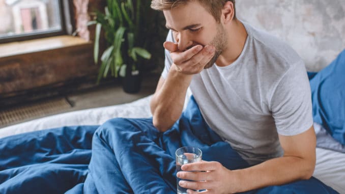 young man taking pill