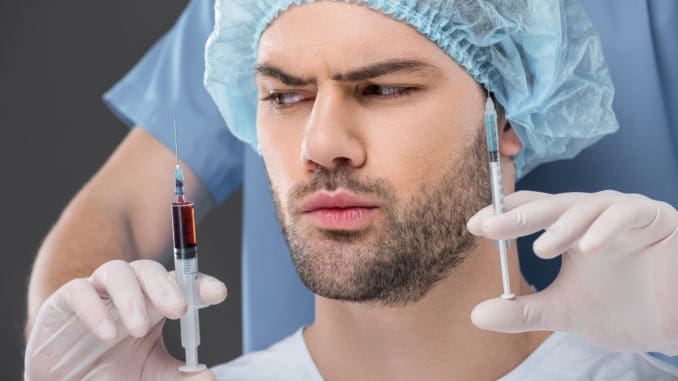 handsome man in medical cap choosing beauty injections isolated on grey