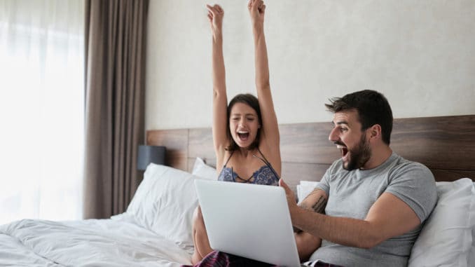 happy couple in the bed. Modern lifestyle concept. Young happy couple in the bed.