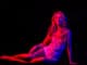 Sensual girl with fit body in red light