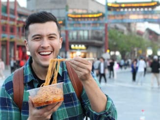 Man eating street food in Asia.