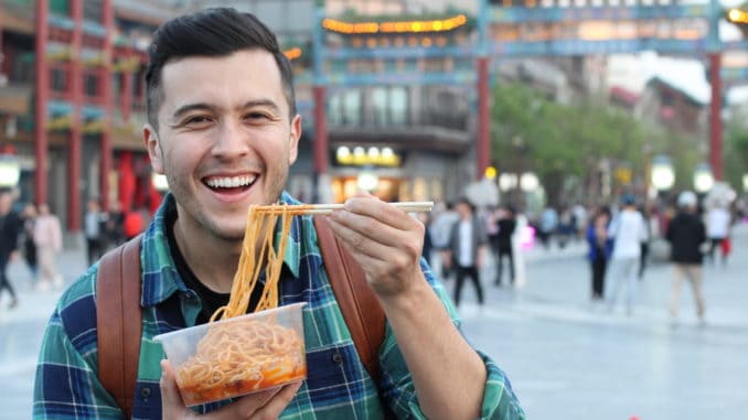 Man eating street food in Asia.