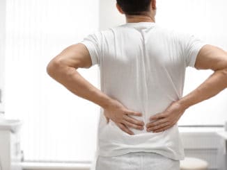 Man suffering from back pain in orthopedist s office