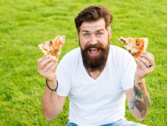 A lot of pizza. bearded men hipster eat pizza