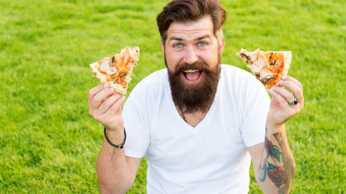 A lot of pizza. bearded men hipster eat pizza