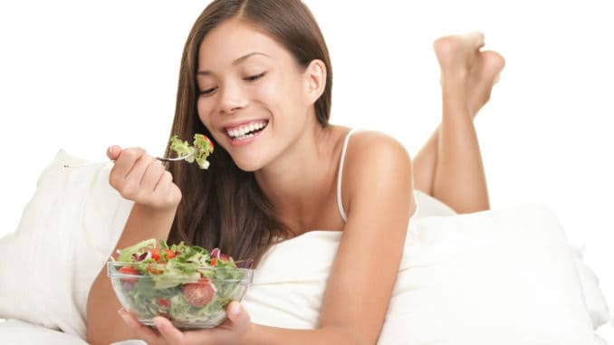 Healthy woman eating salad in bed Salad woman eating healthy salad