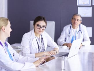 Doctors having a medical discussion in a meeting room.