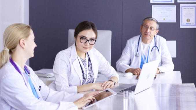 Doctors having a medical discussion in a meeting room.