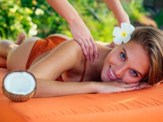 snow-white smile,perfect skin woman plumeria flower relaxing massage on beach.girl pampering in the Thai spa salon and coconut oil masseuse bliss tropical paradise.tourist traveling rich resort.