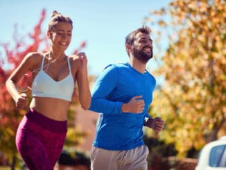 Young happy men and women jogging at the park. healthy lifestyle