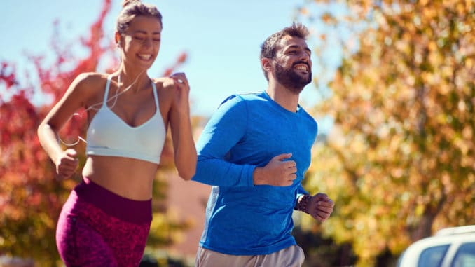 Young happy men and women jogging at the park. healthy lifestyle