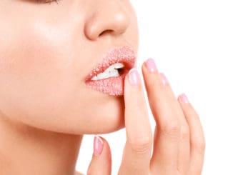 Young woman with sugar lips on white background, closeup