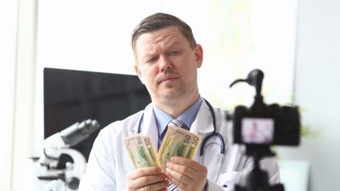 counting earned money in front of videocamera.