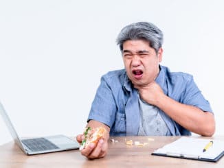 man having symptoms of food stuck in his throat Since he eats hamburgers