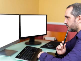 Man thinking on front of computer. Man Teleworking.