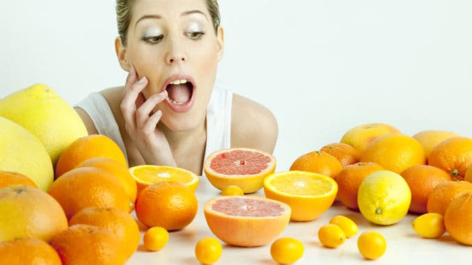 portrait of young woman with citrus fruit Portrait of young woman with citrus fruit