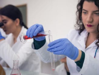 Group of Laboratory scientists working at lab with test tubes,