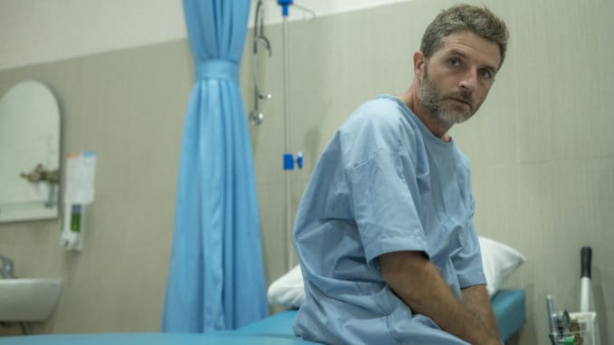 dreamstime_m_184475127 Scared and worried man hospitalized