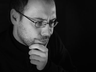 Man thinking with beard and glasses, white and black picture