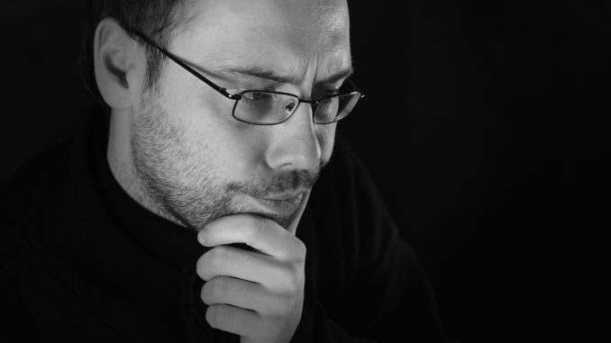 Man thinking with beard and glasses, white and black picture