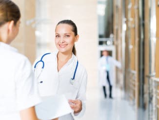 Two doctors talking in the lobby of the hospital