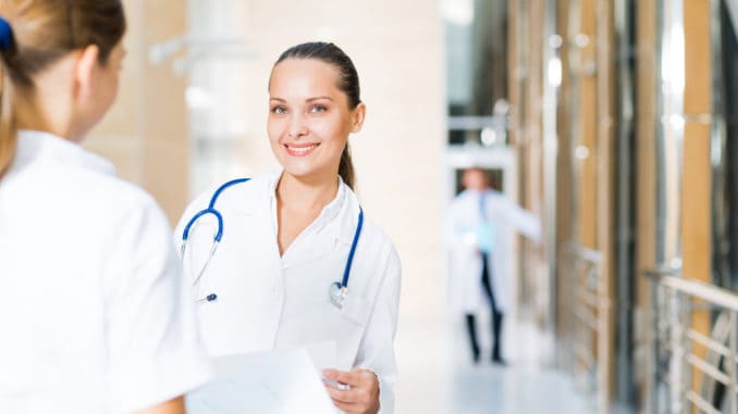 Two doctors talking in the lobby of the hospital