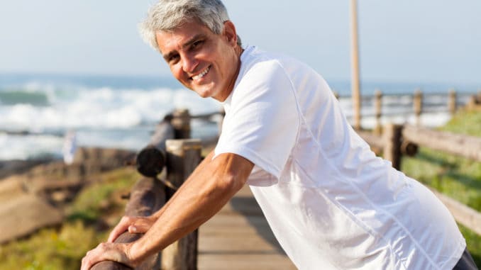 Healthy middle aged man workout at the beach in the morning