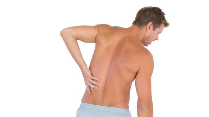 Man rubbing his back because of a back pain on white background